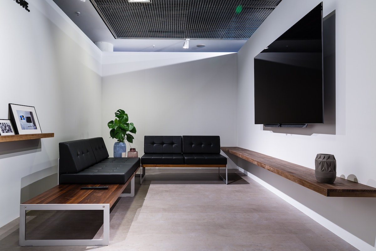 a clean, simple dispensary waiting room with prominent TV